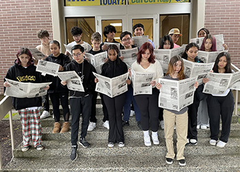 High school students with newspaper